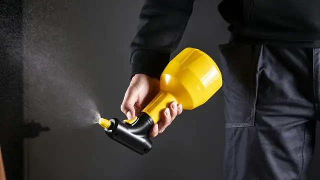 Hand holding a garden sprayer