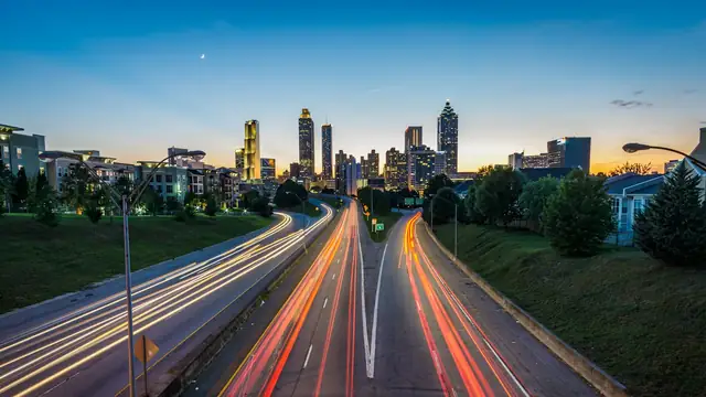 Highway with light trails at golden hour